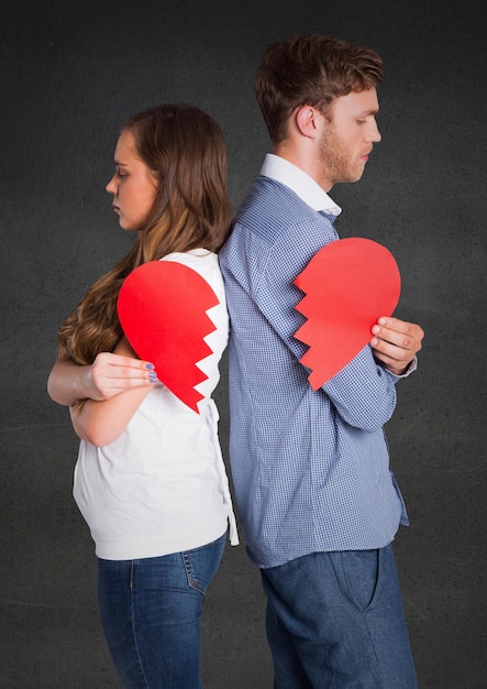 Depressed couple holding broken heart