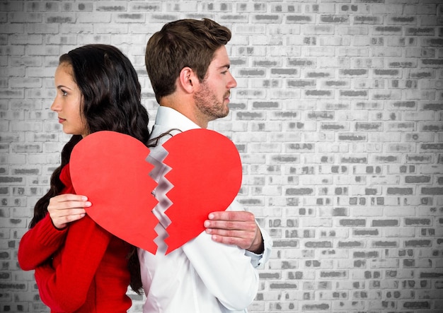 Depressed couple holding broken heart