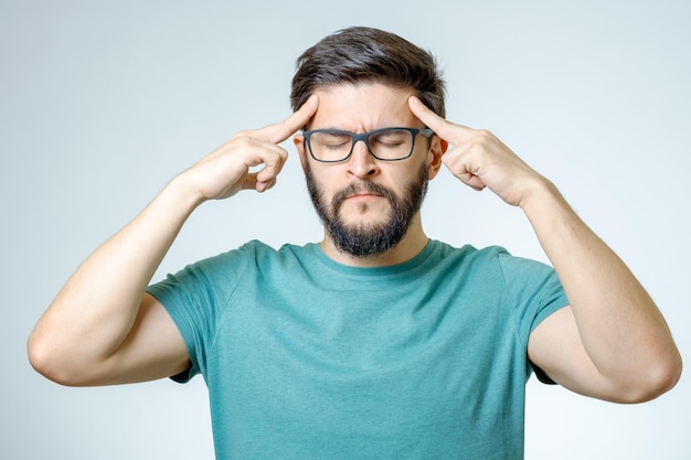 Depressed handsome bearded man touching having a headache