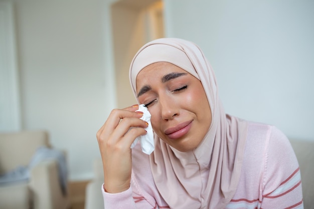 Depressed Muslim lady in hijab headscarf sadness and frustration crying woman despair emotions expression The life of a woman in the Muslim world is doomed to live in fear and suffering