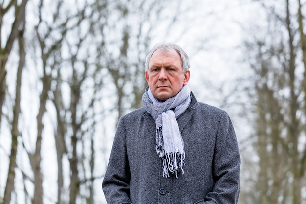 Depressed or sad man walking in winter