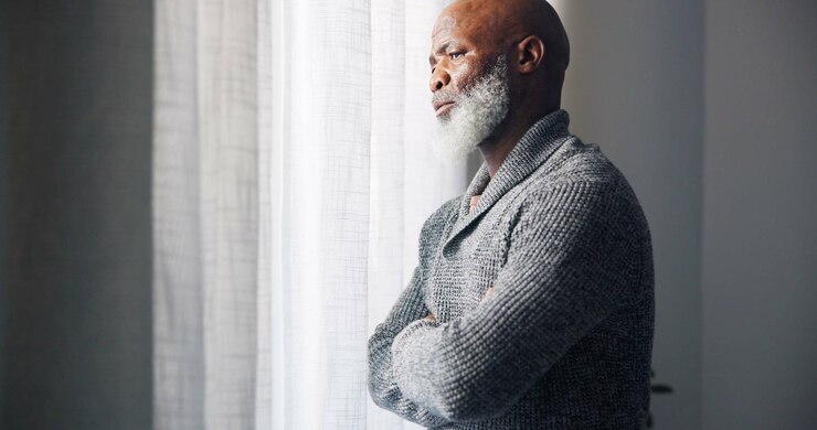 Photo depressed sad and senior man in home with mourning and memory with mental health problem elderly male person sorry and anxiety in a house feeling disappointed in retirement with grief and fail