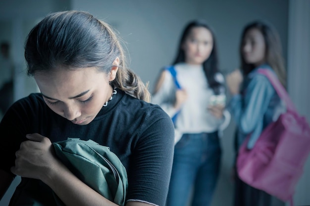 depressed teenage girl bullied with her friends