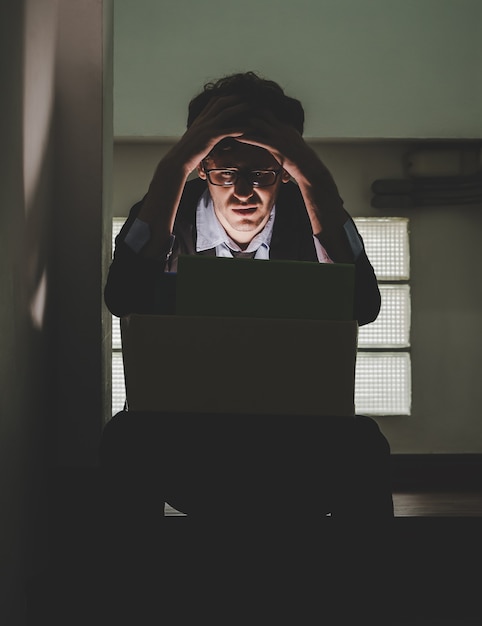 Photo depressed umemployed business office worker is sitting with card box in narrow dark stair for getting fired concept.