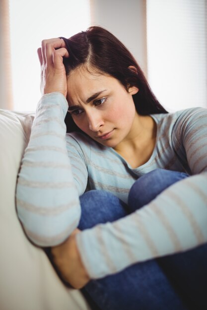 Depressed woman sitting at home