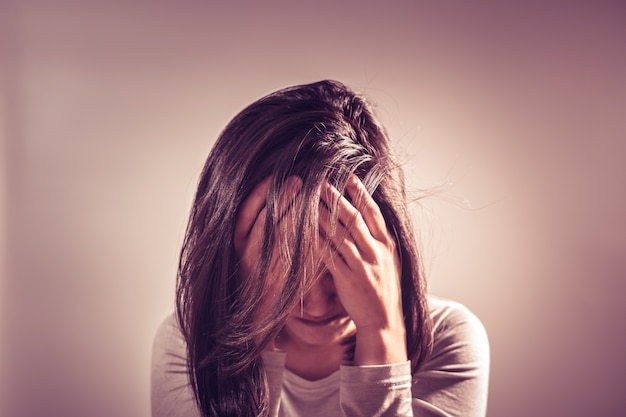 Depressed women sitting in dark room, alone, sadness, emotional concept