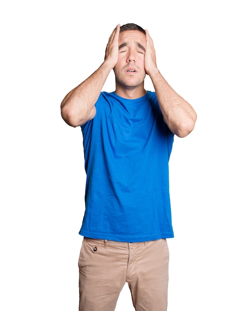 Depressed young man against white background