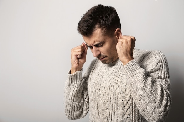 Depressed young man on light background