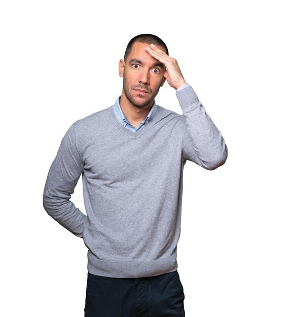 Depressed young man posing against background