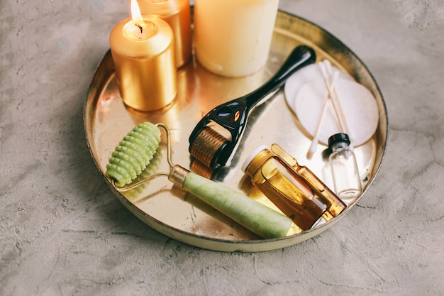 Dermaroller and serum next to an anti aging face cream Beauty industry Close-up