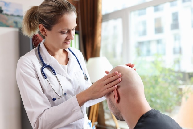 Dermatologist examines head skin of bald male person