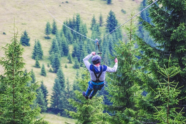 Descent from the mountain on a metal cable Zipline is an extreme kind of fun in nature