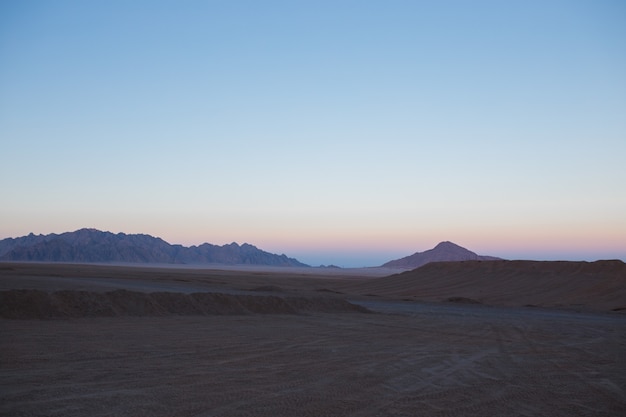 The desert of egypt in the setting sun mountains and sand