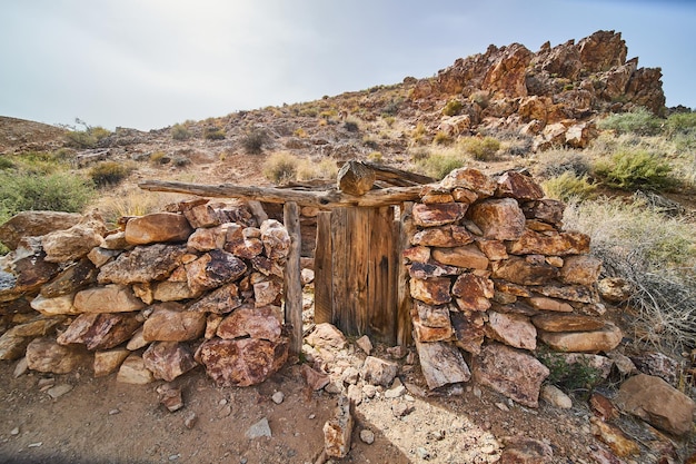 Desert hills with abandoned stone structure by old mine