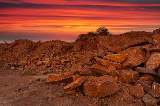 A desert landscape with rocks and huge stones in the foreground taken in a granite quarry in Ukraine