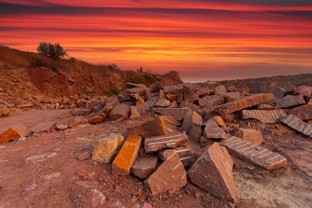 A desert landscape with rocks and huge stones in the foreground taken in a granite quarry in Ukraine