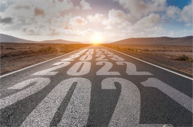 Desert landscape with the years 2021, 2022, 2023, 2024 and 2025 painted in white on the road.