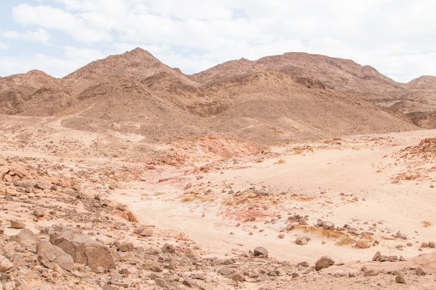 Desert, mountains, rocks and cloudy sky