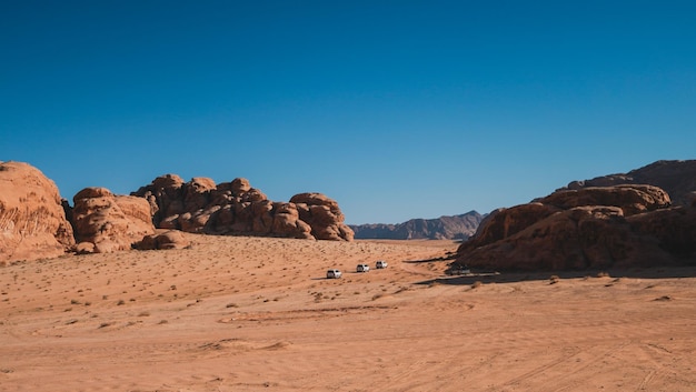 A desert scene with a mountain in the background