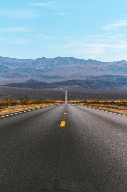 Desert scenic road in Death Valley with mountain backdrop California Amazing panorama of desert