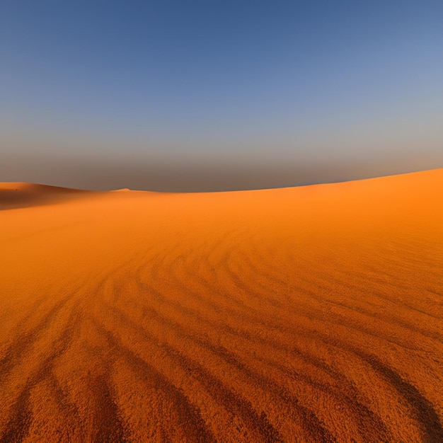 A desert with a clear blue sky and a large sand dune.