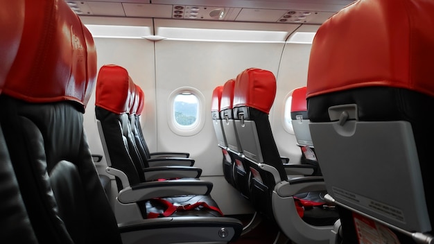 Deserted aircraft interior, empty passenger seats.