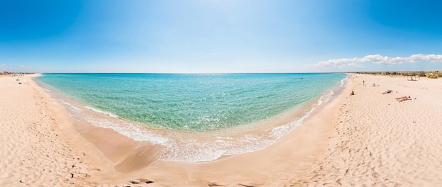 Deserted beach with white sand and crystal clear azure sea blurred background for your text concept