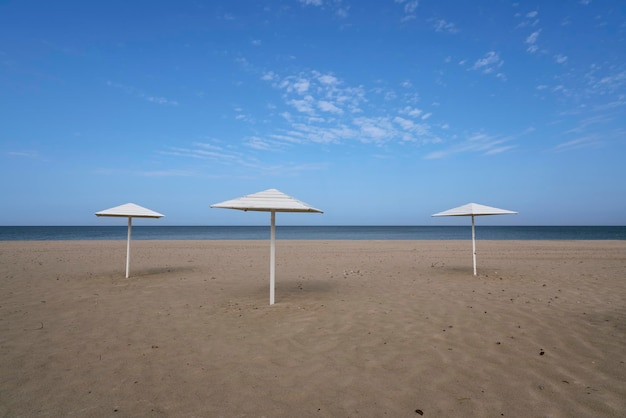 A deserted beach with wooden umbrellas on the shore of Baltic Sea Yantarny Kaliningrad region Russia