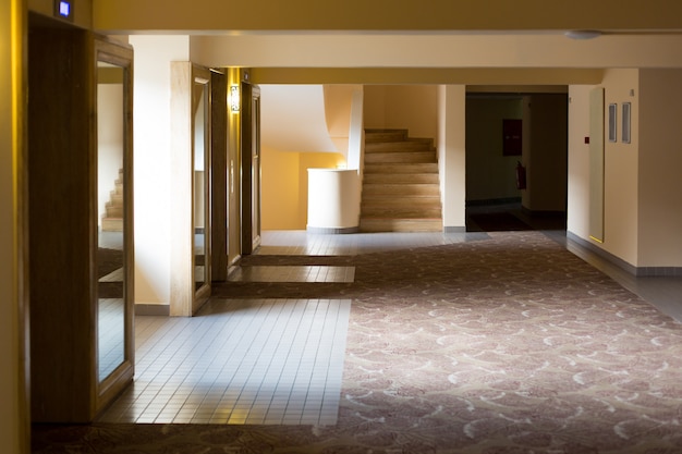 deserted beige corridor in the early morning at the hotel.