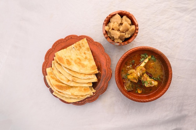 Desi breakfast mutton nalli nihari halwa and paratha served in dish isolated on background top view of bangladesi breakfast