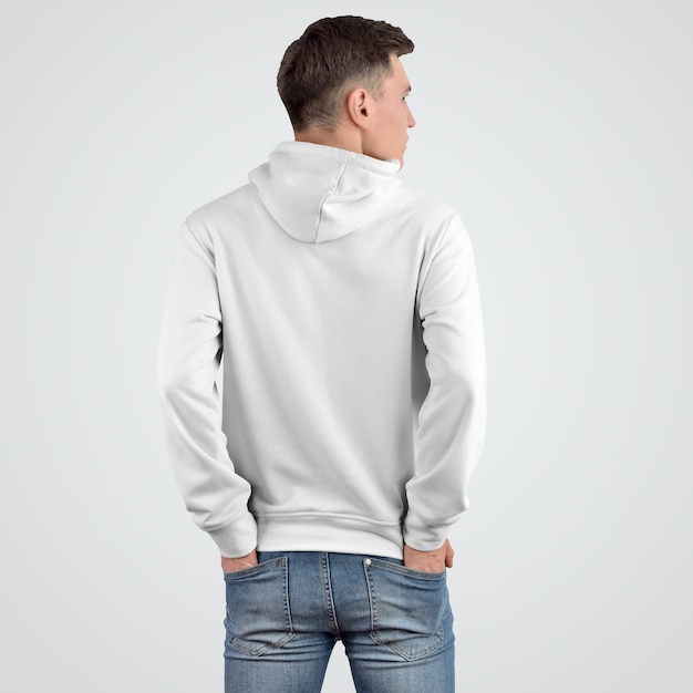 Design of a white hoodie mockup on a young man standing with his back.
Presentation of a template of fashionable clothes for a store.
Modern apparel