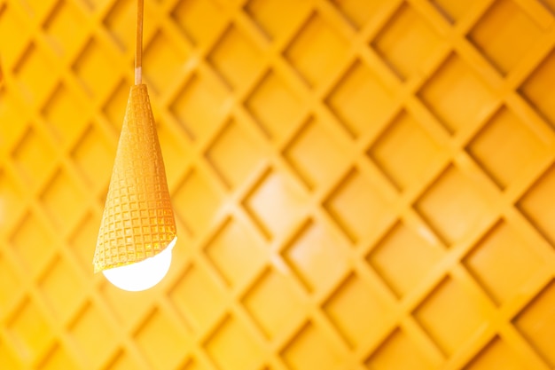 Designed yellow lamps on wooden background. White lights in the room