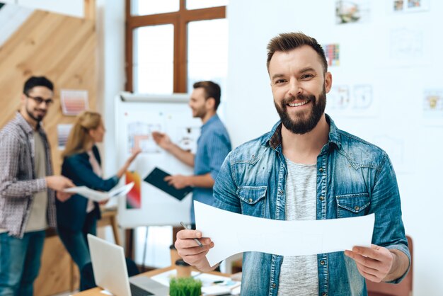 Designer architect is posing with blueprints