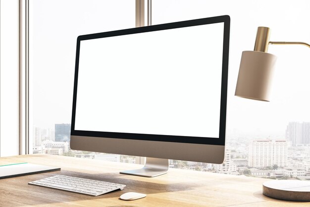 Designer desktop with white computer screen