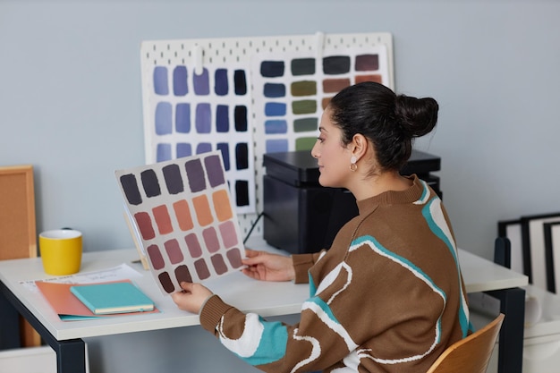 Designer examining color pattern in office