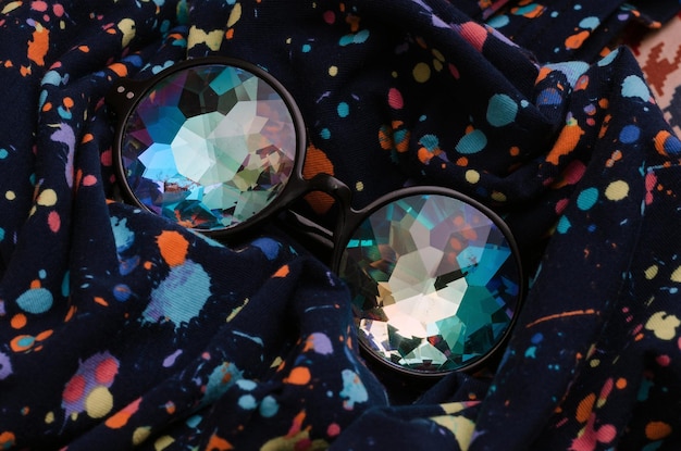 Photo designer glasses kaleidoscope on abstract textile background