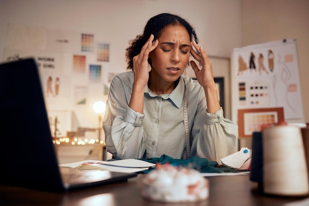 Designer headache and woman stress in studio for creative burnout management anxiety or fashion mistake Black woman frustrated and overworked fashion designer or tailor working on clothes design