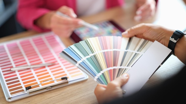 designer and her client choosing colors for home renovation design studio concept two people