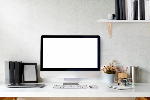 Designer Loft workspace with mockup desktop computer and poster. 