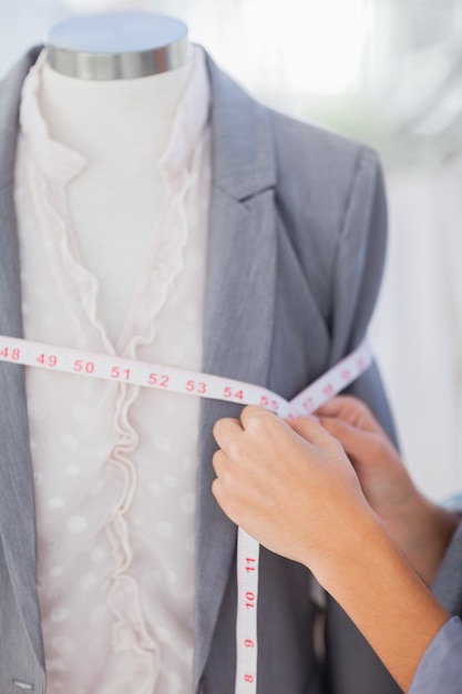 Photo designer measuring blazer