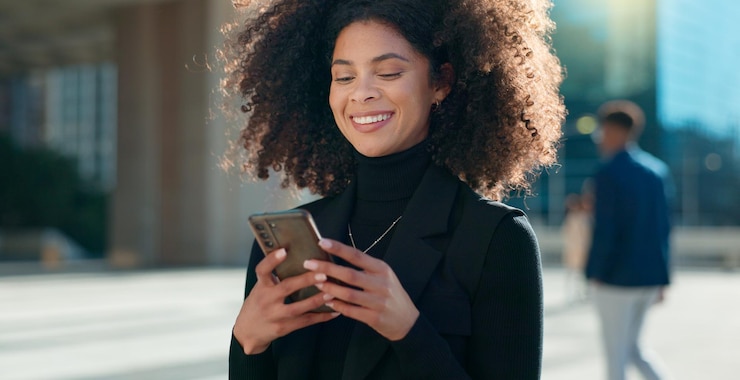 Photo designer mobile app or happy woman in city on social media internet post or web chat notification news blog smile or girl entrepreneur on smartphone texting networking or typing online in town