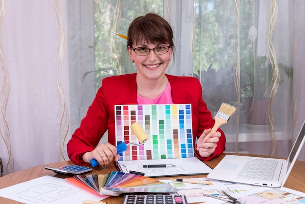 Designer showing colour palette and painting tools