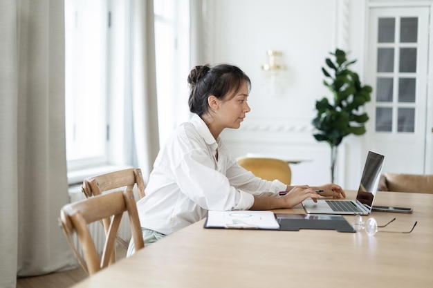 Designer student woman routine job the website uses a laptop to work on its project online