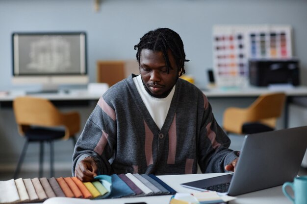 Photo designer using computer at his work