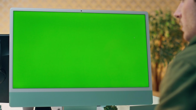 Designer working mockup computer at cabinet close up man staring green screen