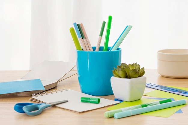 Desk arrangement with pen container and plant