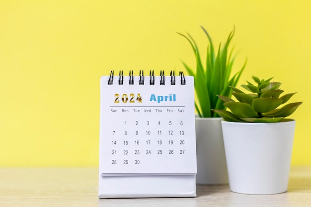 Desk calendar for April 2024 and a clock on the table