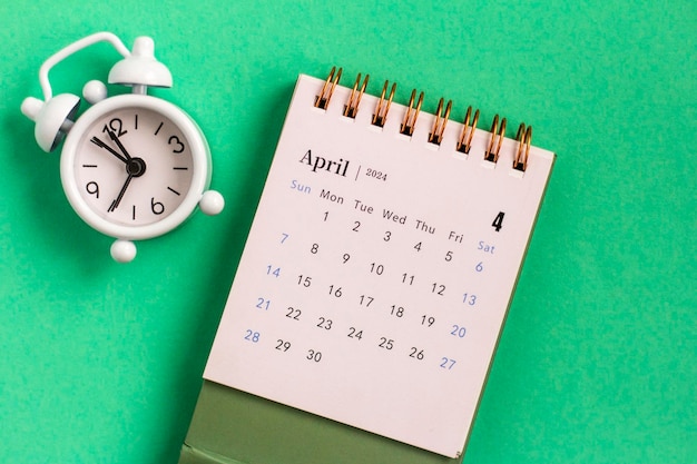 Desk calendar for April 2024 on a green background