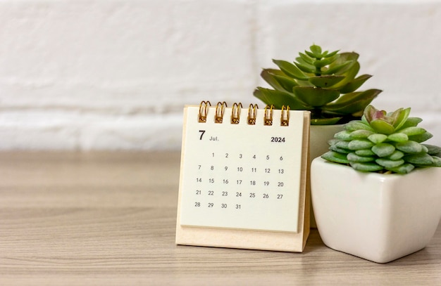 Photo desk calendar for july 2024 on the table with copy space