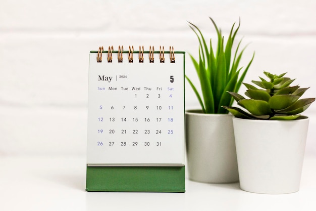 Desk calendar for May 2024 on a green background